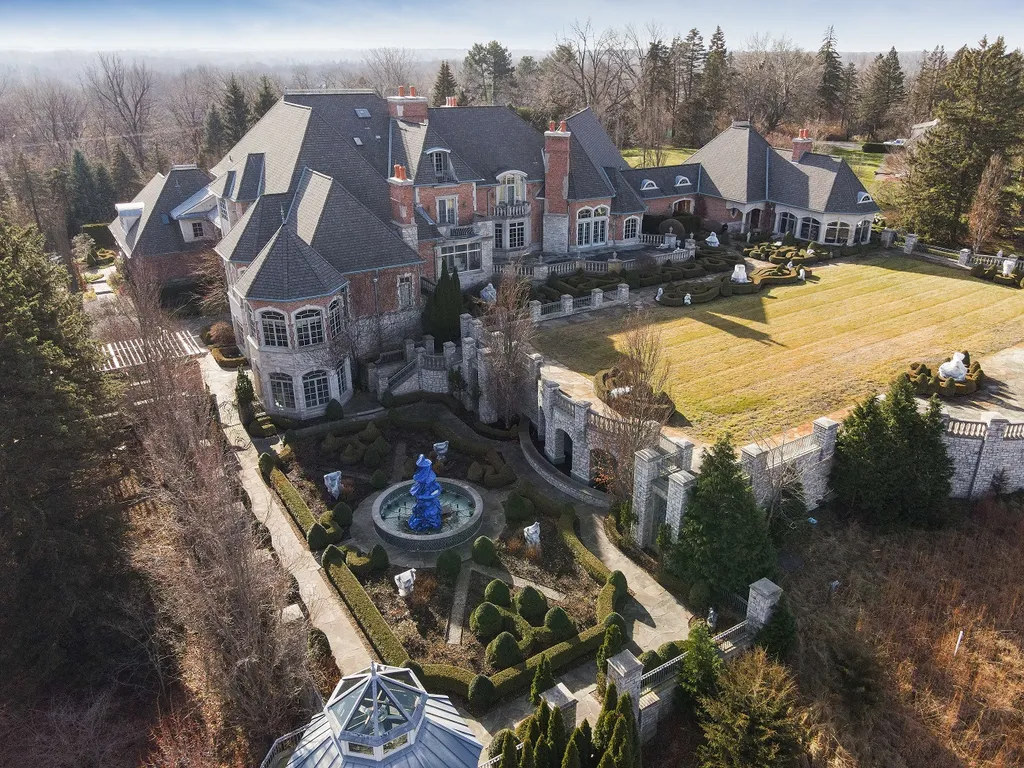 1558 Dutton Road Home in Rochester, Michigan. Discover the epitome of luxury living at this Country Estate in Oakland Township. Spread across 22 acres, the home features hand-carved wooden archways, hand-painted ceiling frescos, and hand-cut stone and gold-leafed accents.