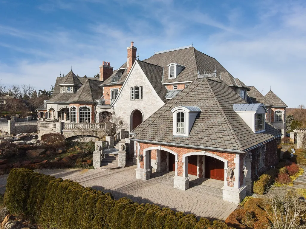1558 Dutton Road Home in Rochester, Michigan. Discover the epitome of luxury living at this Country Estate in Oakland Township. Spread across 22 acres, the home features hand-carved wooden archways, hand-painted ceiling frescos, and hand-cut stone and gold-leafed accents.