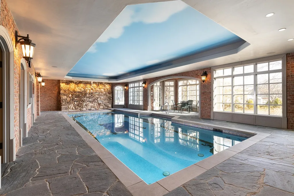 1558 Dutton Road Home in Rochester, Michigan. Discover the epitome of luxury living at this Country Estate in Oakland Township. Spread across 22 acres, the home features hand-carved wooden archways, hand-painted ceiling frescos, and hand-cut stone and gold-leafed accents.
