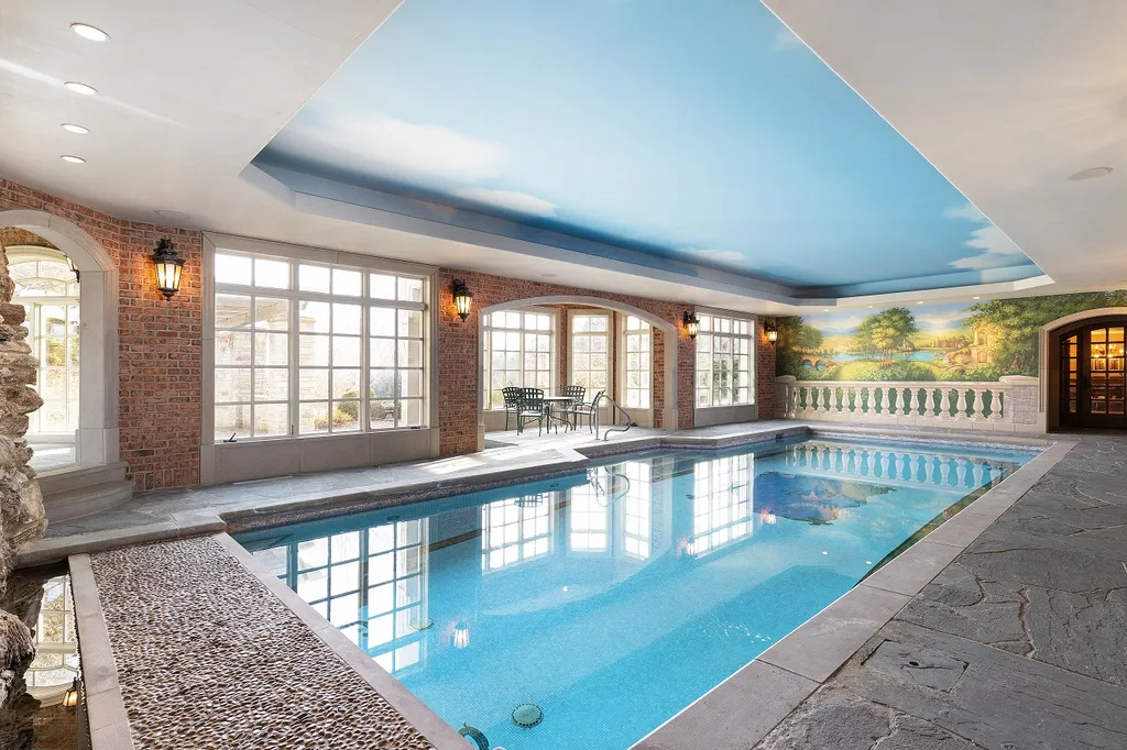 1558 Dutton Road Home in Rochester, Michigan. Discover the epitome of luxury living at this Country Estate in Oakland Township. Spread across 22 acres, the home features hand-carved wooden archways, hand-painted ceiling frescos, and hand-cut stone and gold-leafed accents.