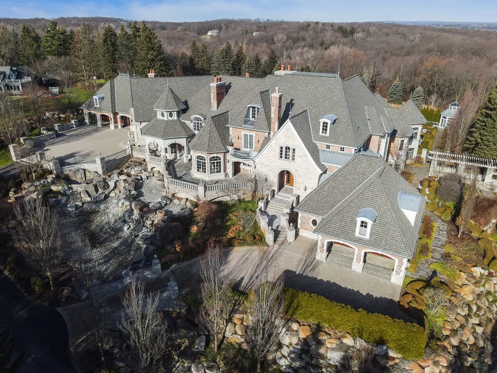 1558 Dutton Road Home in Rochester, Michigan. Discover the epitome of luxury living at this Country Estate in Oakland Township. Spread across 22 acres, the home features hand-carved wooden archways, hand-painted ceiling frescos, and hand-cut stone and gold-leafed accents.
