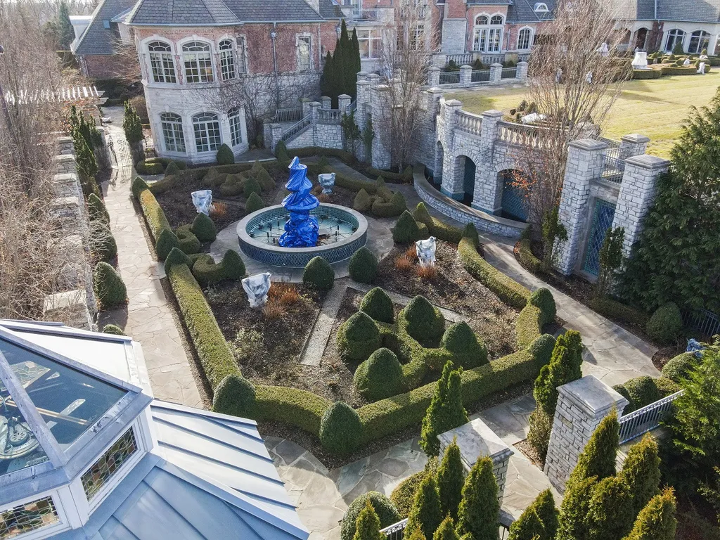1558 Dutton Road Home in Rochester, Michigan. Discover the epitome of luxury living at this Country Estate in Oakland Township. Spread across 22 acres, the home features hand-carved wooden archways, hand-painted ceiling frescos, and hand-cut stone and gold-leafed accents.