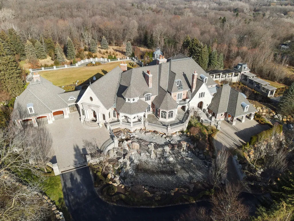 1558 Dutton Road Home in Rochester, Michigan. Discover the epitome of luxury living at this Country Estate in Oakland Township. Spread across 22 acres, the home features hand-carved wooden archways, hand-painted ceiling frescos, and hand-cut stone and gold-leafed accents.