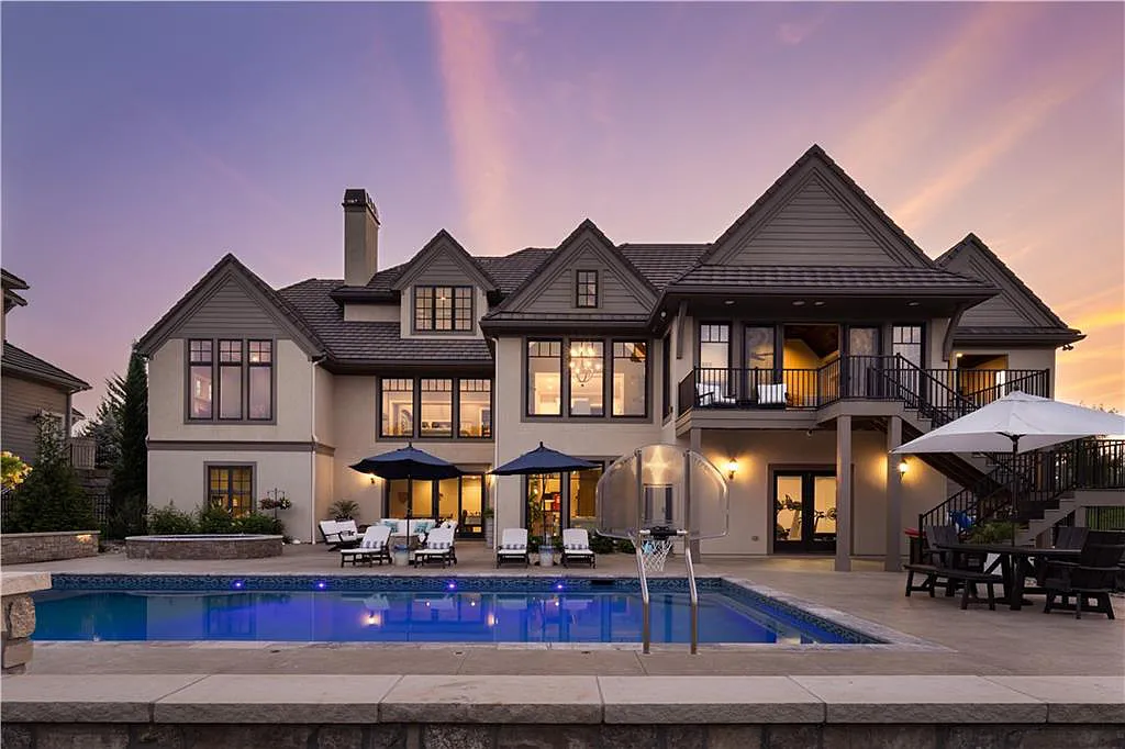 15905 Cody Street Home in Overland Park, Kansas. Step into the world of luxury with this custom-built Holthaus estate featuring magazine-worthy interiors and extensive upgrades. From arched doorways to wide plank rough sawn wood floors, every detail exudes beauty and practicality. Enjoy generous room sizes, beamed ceilings, and designer finishes throughout the 9,000+ square feet of living space. 