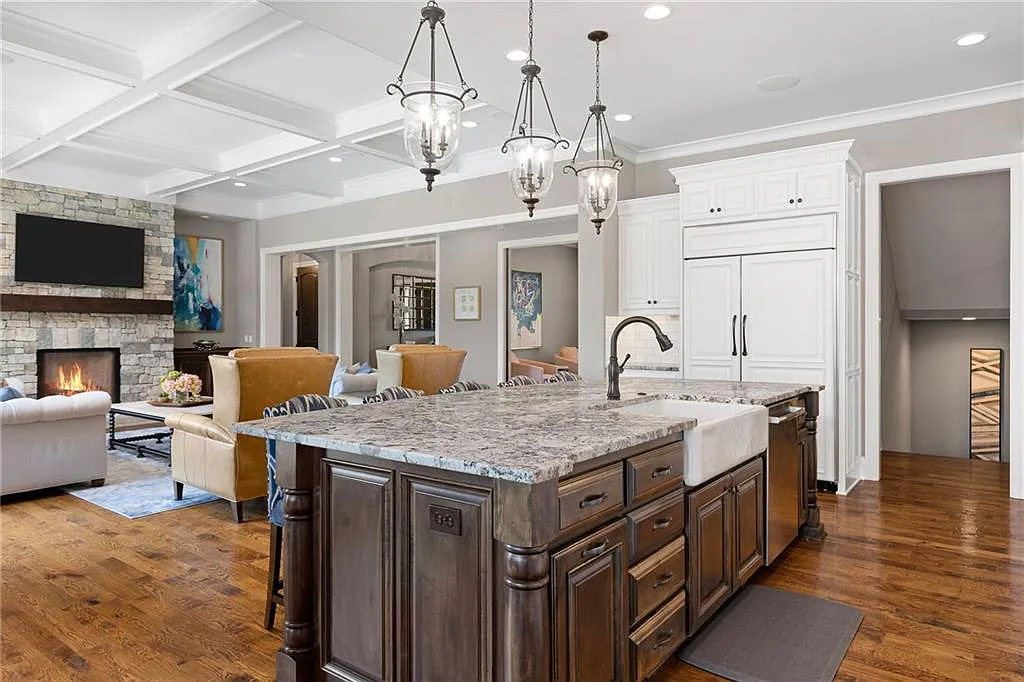 15905 Cody Street Home in Overland Park, Kansas. Step into the world of luxury with this custom-built Holthaus estate featuring magazine-worthy interiors and extensive upgrades. From arched doorways to wide plank rough sawn wood floors, every detail exudes beauty and practicality. Enjoy generous room sizes, beamed ceilings, and designer finishes throughout the 9,000+ square feet of living space. 