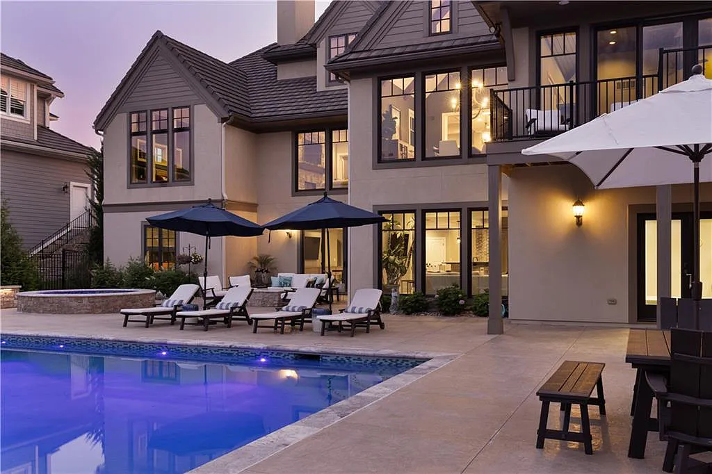 15905 Cody Street Home in Overland Park, Kansas. Step into the world of luxury with this custom-built Holthaus estate featuring magazine-worthy interiors and extensive upgrades. From arched doorways to wide plank rough sawn wood floors, every detail exudes beauty and practicality. Enjoy generous room sizes, beamed ceilings, and designer finishes throughout the 9,000+ square feet of living space. 