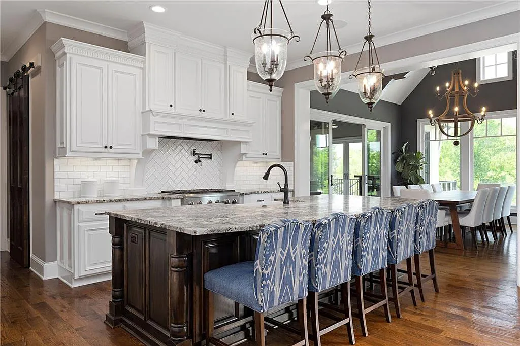 15905 Cody Street Home in Overland Park, Kansas. Step into the world of luxury with this custom-built Holthaus estate featuring magazine-worthy interiors and extensive upgrades. From arched doorways to wide plank rough sawn wood floors, every detail exudes beauty and practicality. Enjoy generous room sizes, beamed ceilings, and designer finishes throughout the 9,000+ square feet of living space. 
