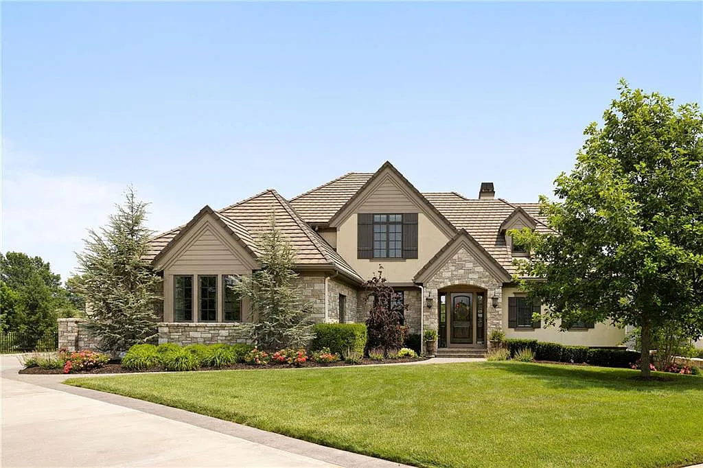15905 Cody Street Home in Overland Park, Kansas. Step into the world of luxury with this custom-built Holthaus estate featuring magazine-worthy interiors and extensive upgrades. From arched doorways to wide plank rough sawn wood floors, every detail exudes beauty and practicality. Enjoy generous room sizes, beamed ceilings, and designer finishes throughout the 9,000+ square feet of living space. 