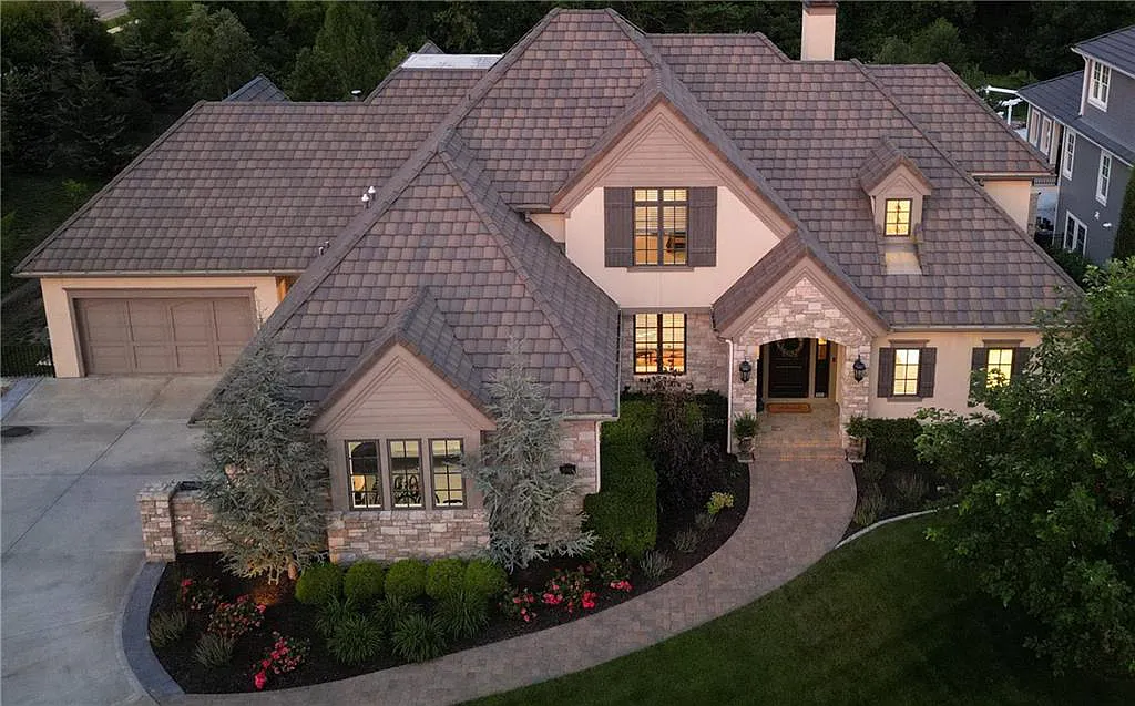 15905 Cody Street Home in Overland Park, Kansas. Step into the world of luxury with this custom-built Holthaus estate featuring magazine-worthy interiors and extensive upgrades. From arched doorways to wide plank rough sawn wood floors, every detail exudes beauty and practicality. Enjoy generous room sizes, beamed ceilings, and designer finishes throughout the 9,000+ square feet of living space. 