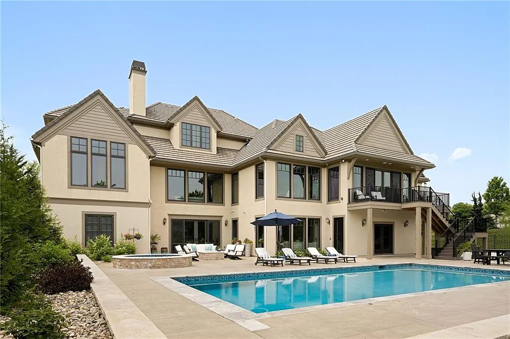 15905 Cody Street Home in Overland Park, Kansas. Step into the world of luxury with this custom-built Holthaus estate featuring magazine-worthy interiors and extensive upgrades. From arched doorways to wide plank rough sawn wood floors, every detail exudes beauty and practicality. Enjoy generous room sizes, beamed ceilings, and designer finishes throughout the 9,000+ square feet of living space. 