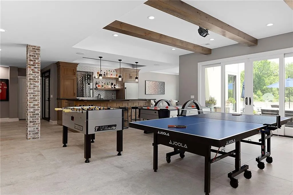 15905 Cody Street Home in Overland Park, Kansas. Step into the world of luxury with this custom-built Holthaus estate featuring magazine-worthy interiors and extensive upgrades. From arched doorways to wide plank rough sawn wood floors, every detail exudes beauty and practicality. Enjoy generous room sizes, beamed ceilings, and designer finishes throughout the 9,000+ square feet of living space. 