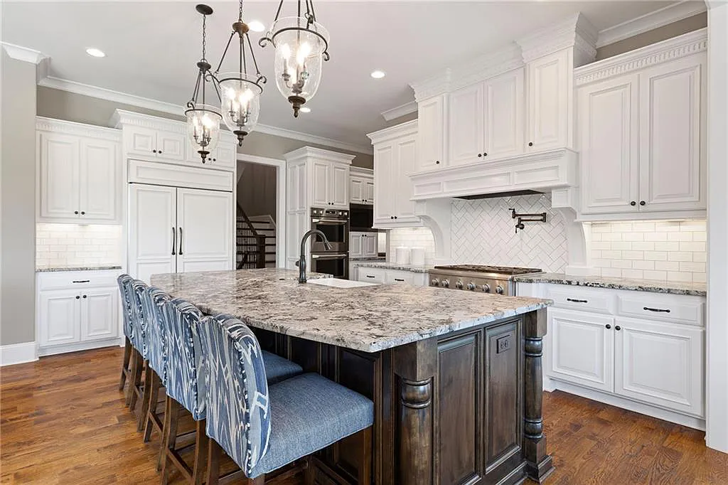 15905 Cody Street Home in Overland Park, Kansas. Step into the world of luxury with this custom-built Holthaus estate featuring magazine-worthy interiors and extensive upgrades. From arched doorways to wide plank rough sawn wood floors, every detail exudes beauty and practicality. Enjoy generous room sizes, beamed ceilings, and designer finishes throughout the 9,000+ square feet of living space. 
