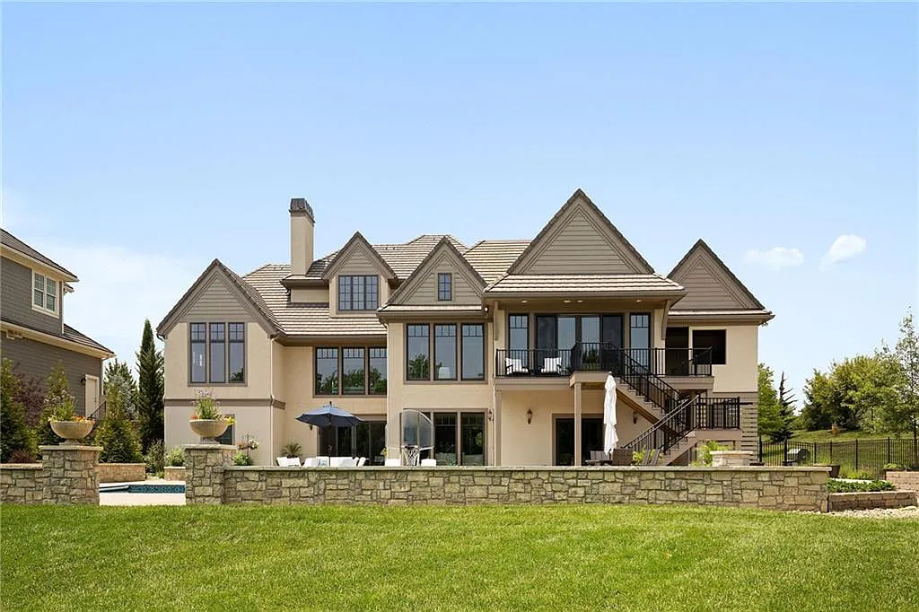 15905 Cody Street Home in Overland Park, Kansas. Step into the world of luxury with this custom-built Holthaus estate featuring magazine-worthy interiors and extensive upgrades. From arched doorways to wide plank rough sawn wood floors, every detail exudes beauty and practicality. Enjoy generous room sizes, beamed ceilings, and designer finishes throughout the 9,000+ square feet of living space. 