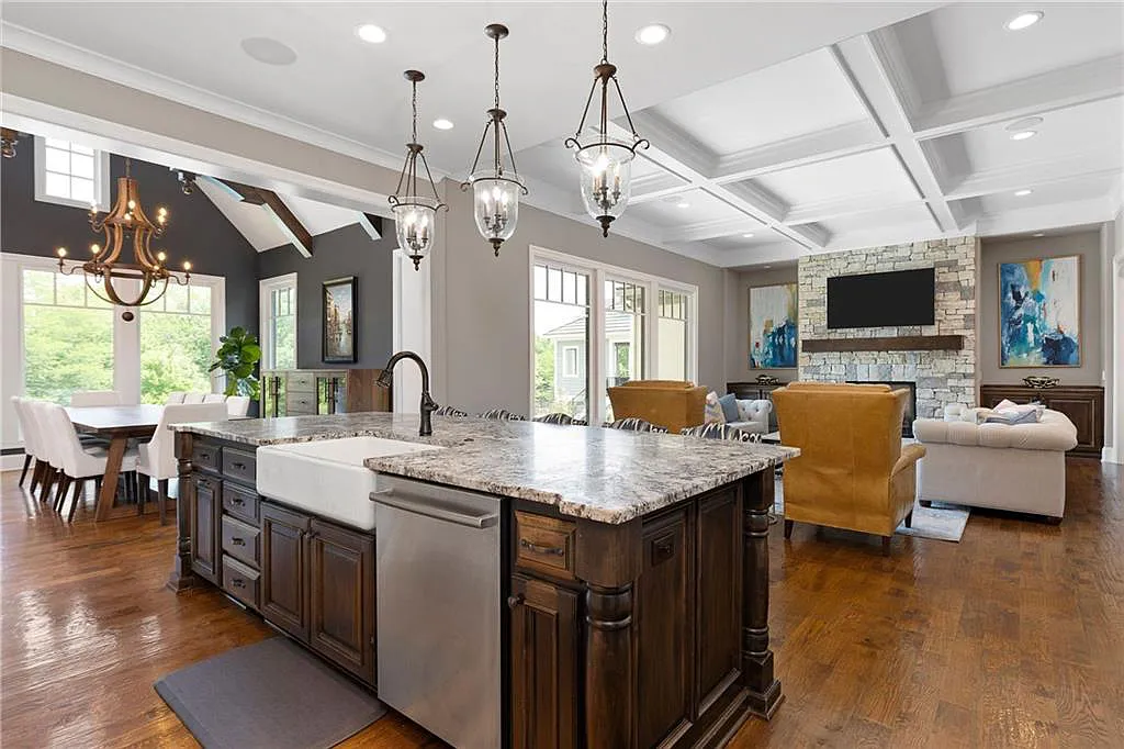 15905 Cody Street Home in Overland Park, Kansas. Step into the world of luxury with this custom-built Holthaus estate featuring magazine-worthy interiors and extensive upgrades. From arched doorways to wide plank rough sawn wood floors, every detail exudes beauty and practicality. Enjoy generous room sizes, beamed ceilings, and designer finishes throughout the 9,000+ square feet of living space. 