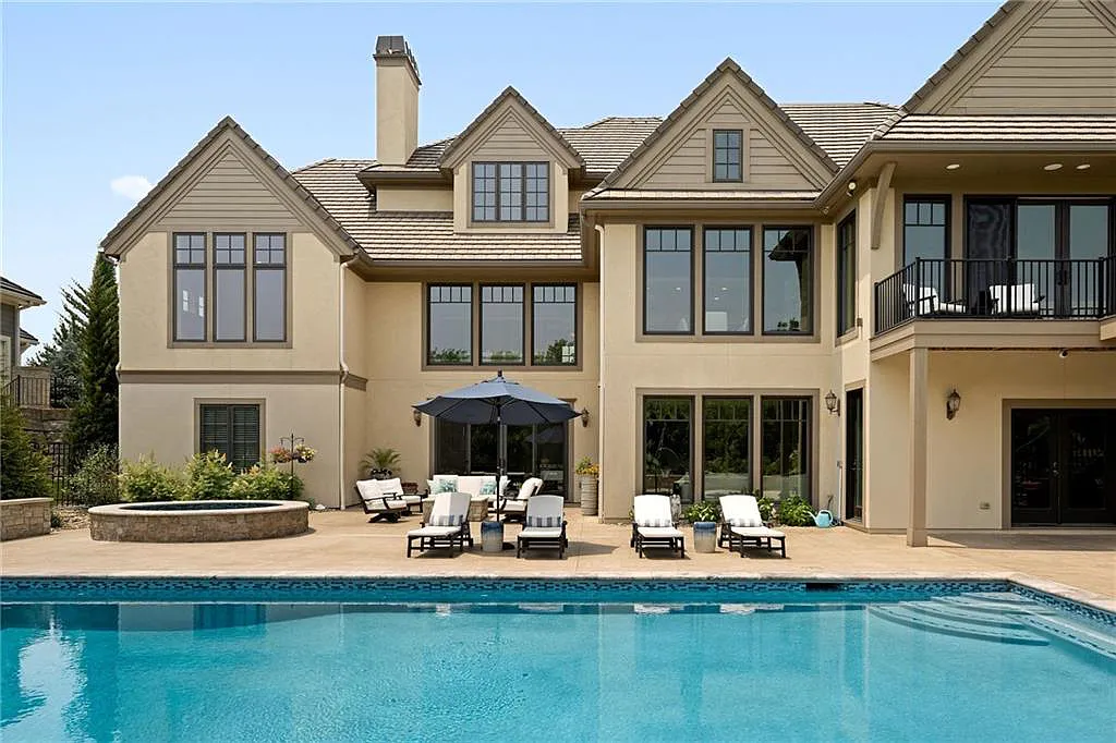 15905 Cody Street Home in Overland Park, Kansas. Step into the world of luxury with this custom-built Holthaus estate featuring magazine-worthy interiors and extensive upgrades. From arched doorways to wide plank rough sawn wood floors, every detail exudes beauty and practicality. Enjoy generous room sizes, beamed ceilings, and designer finishes throughout the 9,000+ square feet of living space. 