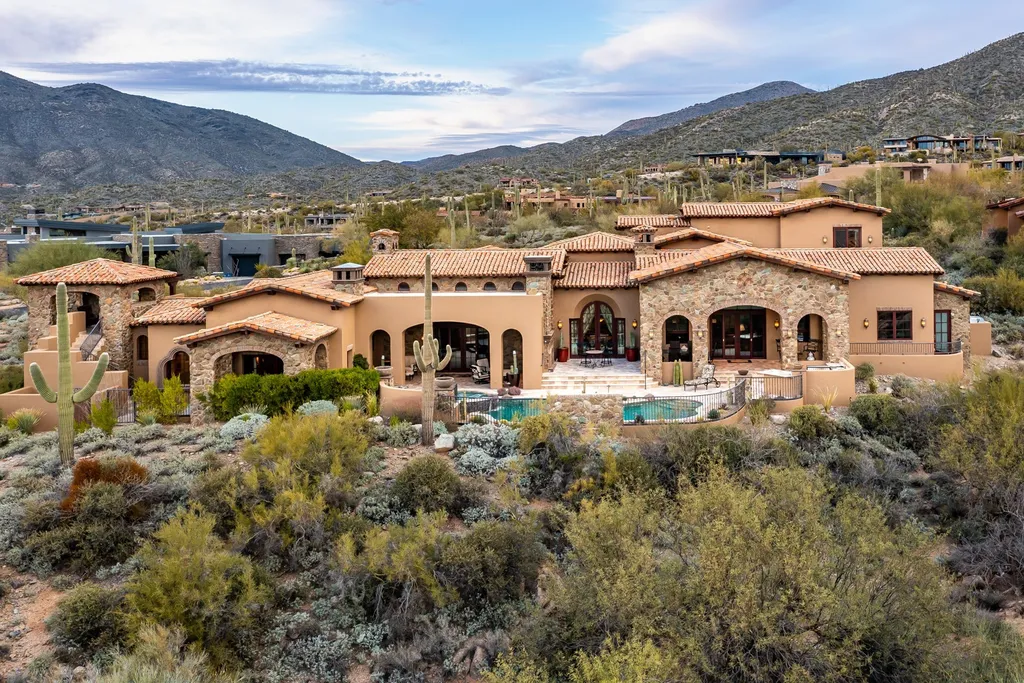 41781 N 99th Way Home in Scottsdale, Arizona. Explore this splendid Old World estate with GOLF Membership available, showcasing warmth, comfort, and unparalleled quality. From the intricately designed interiors to the resort-style patio and serene view terrace, every detail exudes thoughtful craftsmanship and fine materials. 