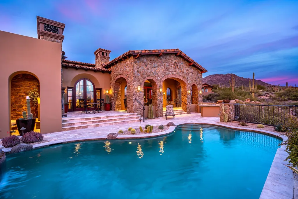 41781 N 99th Way Home in Scottsdale, Arizona. Explore this splendid Old World estate with GOLF Membership available, showcasing warmth, comfort, and unparalleled quality. From the intricately designed interiors to the resort-style patio and serene view terrace, every detail exudes thoughtful craftsmanship and fine materials. 