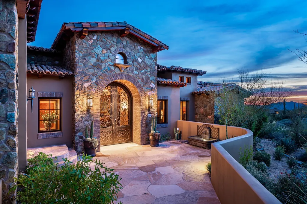 41781 N 99th Way Home in Scottsdale, Arizona. Explore this splendid Old World estate with GOLF Membership available, showcasing warmth, comfort, and unparalleled quality. From the intricately designed interiors to the resort-style patio and serene view terrace, every detail exudes thoughtful craftsmanship and fine materials. 