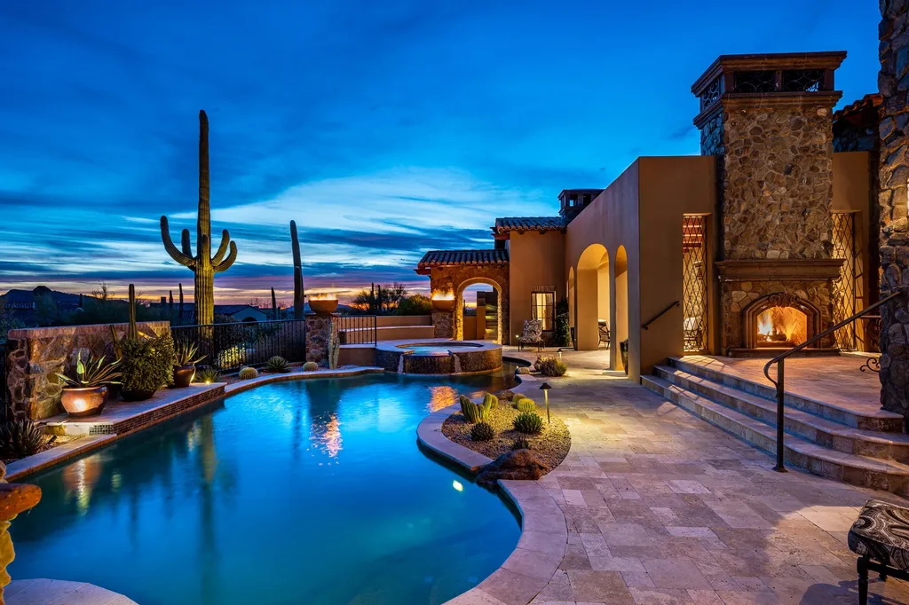 41781 N 99th Way Home in Scottsdale, Arizona. Explore this splendid Old World estate with GOLF Membership available, showcasing warmth, comfort, and unparalleled quality. From the intricately designed interiors to the resort-style patio and serene view terrace, every detail exudes thoughtful craftsmanship and fine materials. 