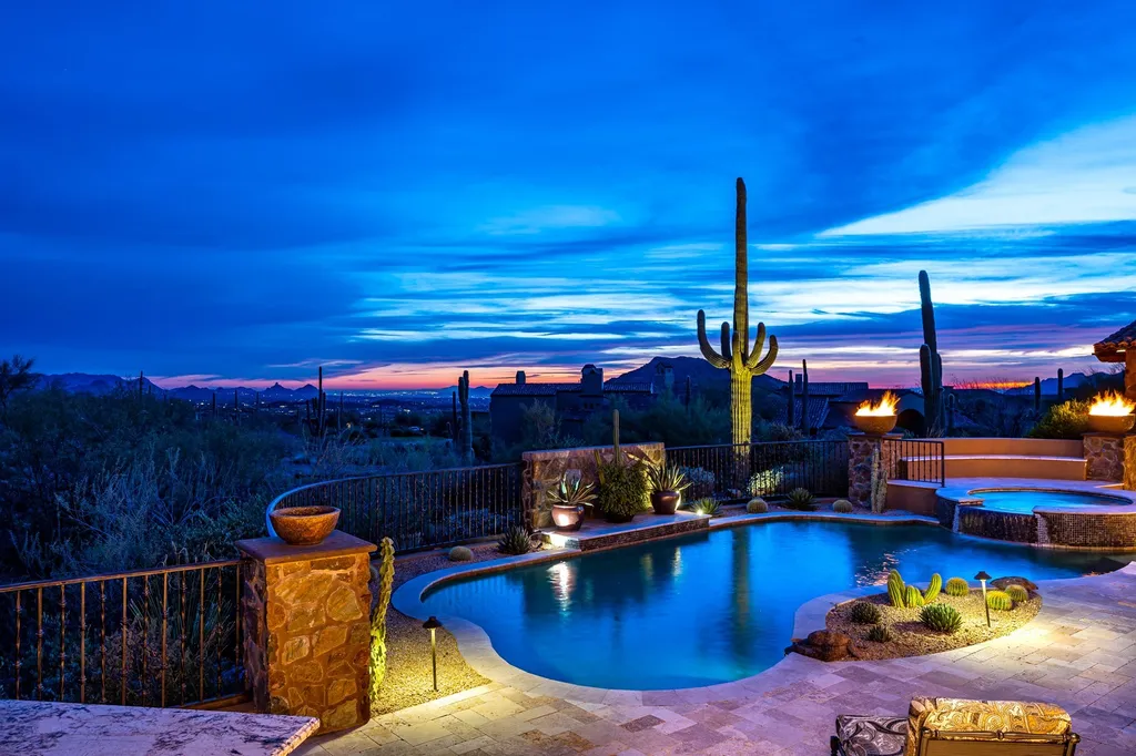 41781 N 99th Way Home in Scottsdale, Arizona. Explore this splendid Old World estate with GOLF Membership available, showcasing warmth, comfort, and unparalleled quality. From the intricately designed interiors to the resort-style patio and serene view terrace, every detail exudes thoughtful craftsmanship and fine materials. 
