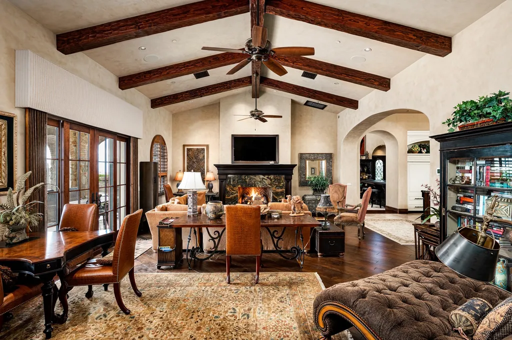 41781 N 99th Way Home in Scottsdale, Arizona. Explore this splendid Old World estate with GOLF Membership available, showcasing warmth, comfort, and unparalleled quality. From the intricately designed interiors to the resort-style patio and serene view terrace, every detail exudes thoughtful craftsmanship and fine materials. 