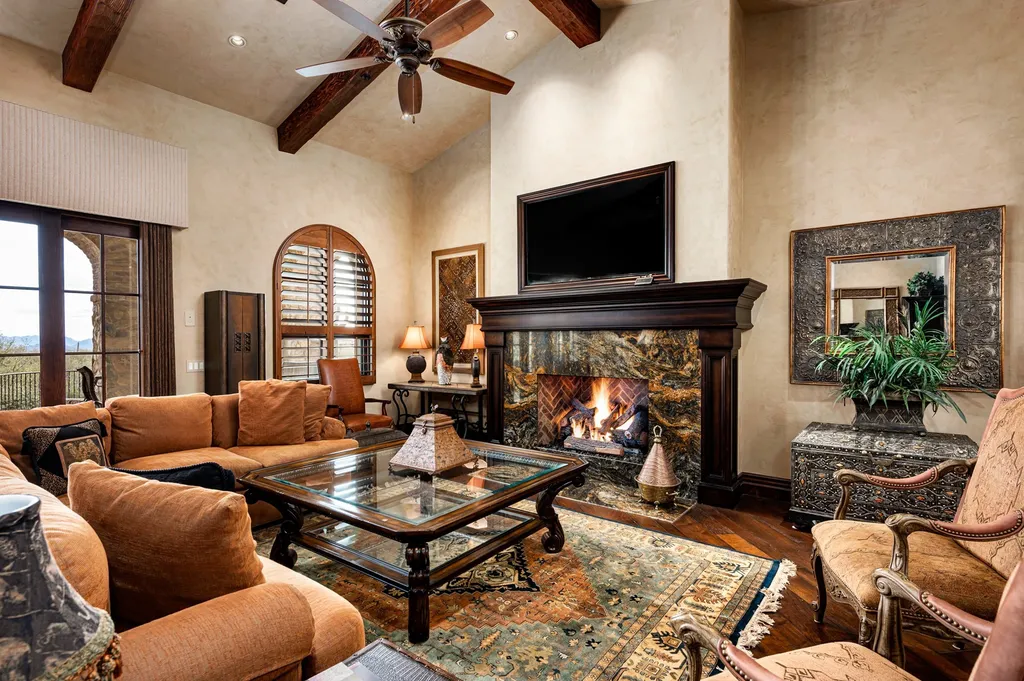 41781 N 99th Way Home in Scottsdale, Arizona. Explore this splendid Old World estate with GOLF Membership available, showcasing warmth, comfort, and unparalleled quality. From the intricately designed interiors to the resort-style patio and serene view terrace, every detail exudes thoughtful craftsmanship and fine materials. 