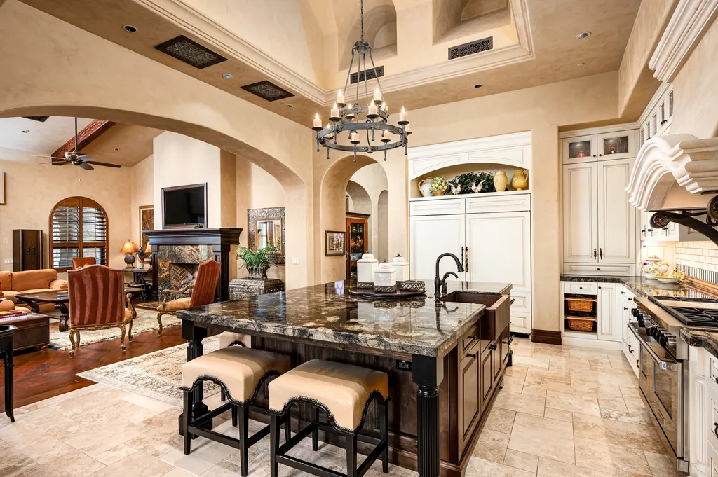 41781 N 99th Way Home in Scottsdale, Arizona. Explore this splendid Old World estate with GOLF Membership available, showcasing warmth, comfort, and unparalleled quality. From the intricately designed interiors to the resort-style patio and serene view terrace, every detail exudes thoughtful craftsmanship and fine materials. 