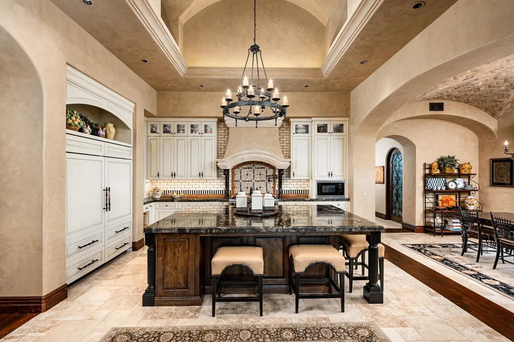 41781 N 99th Way Home in Scottsdale, Arizona. Explore this splendid Old World estate with GOLF Membership available, showcasing warmth, comfort, and unparalleled quality. From the intricately designed interiors to the resort-style patio and serene view terrace, every detail exudes thoughtful craftsmanship and fine materials. 