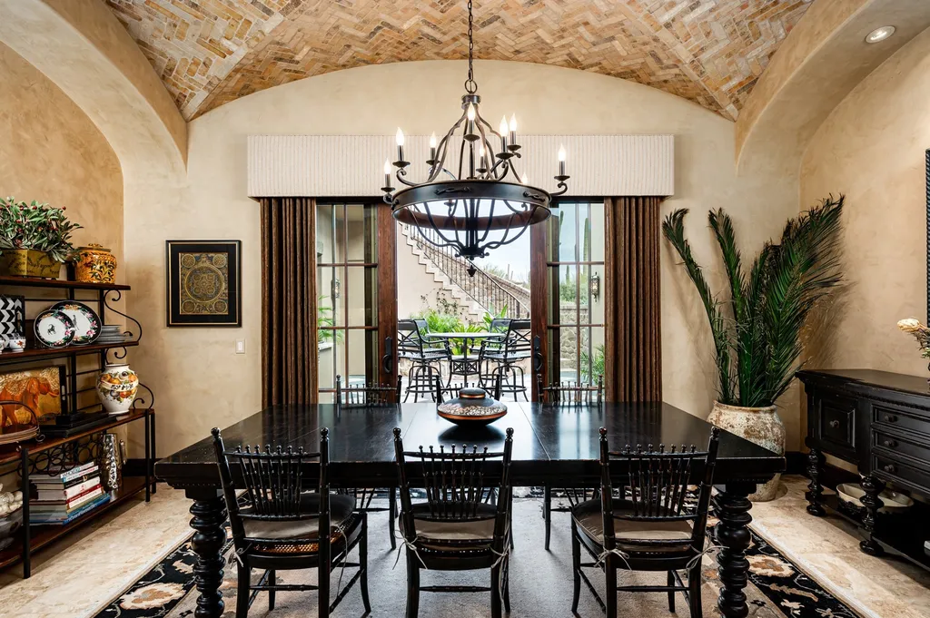 41781 N 99th Way Home in Scottsdale, Arizona. Explore this splendid Old World estate with GOLF Membership available, showcasing warmth, comfort, and unparalleled quality. From the intricately designed interiors to the resort-style patio and serene view terrace, every detail exudes thoughtful craftsmanship and fine materials. 