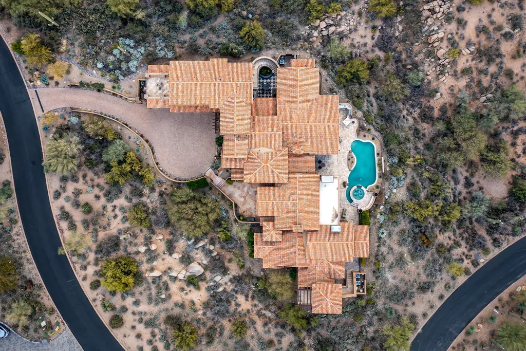 41781 N 99th Way Home in Scottsdale, Arizona. Explore this splendid Old World estate with GOLF Membership available, showcasing warmth, comfort, and unparalleled quality. From the intricately designed interiors to the resort-style patio and serene view terrace, every detail exudes thoughtful craftsmanship and fine materials. 