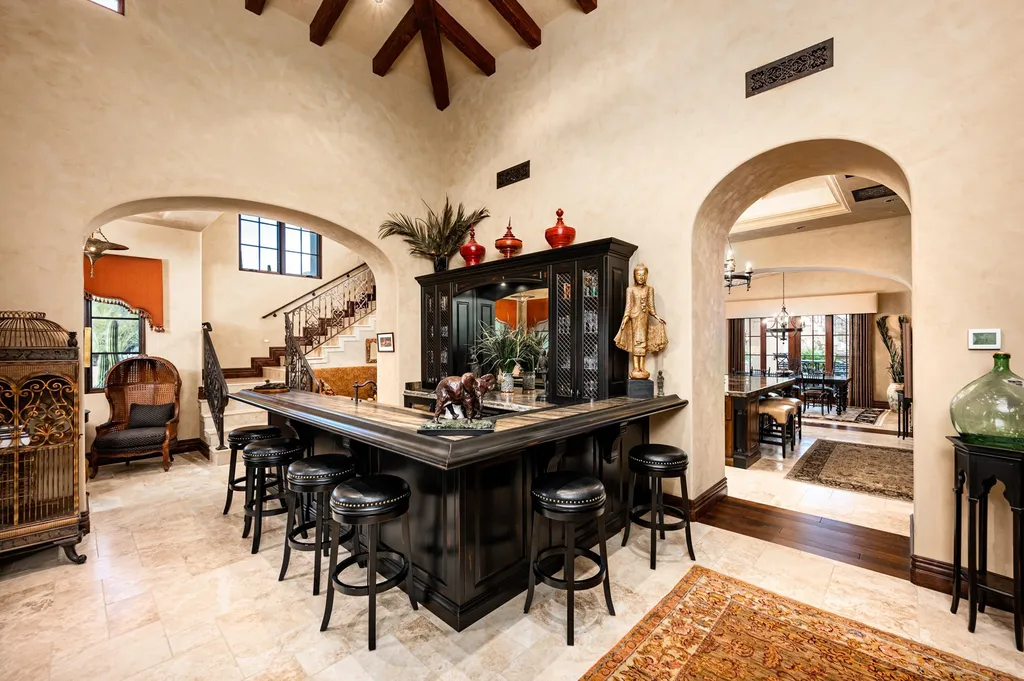41781 N 99th Way Home in Scottsdale, Arizona. Explore this splendid Old World estate with GOLF Membership available, showcasing warmth, comfort, and unparalleled quality. From the intricately designed interiors to the resort-style patio and serene view terrace, every detail exudes thoughtful craftsmanship and fine materials. 