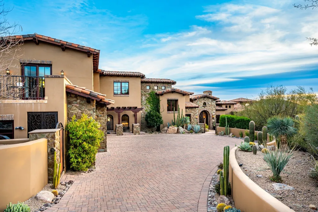 41781 N 99th Way Home in Scottsdale, Arizona. Explore this splendid Old World estate with GOLF Membership available, showcasing warmth, comfort, and unparalleled quality. From the intricately designed interiors to the resort-style patio and serene view terrace, every detail exudes thoughtful craftsmanship and fine materials. 