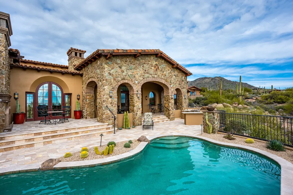 41781 N 99th Way Home in Scottsdale, Arizona. Explore this splendid Old World estate with GOLF Membership available, showcasing warmth, comfort, and unparalleled quality. From the intricately designed interiors to the resort-style patio and serene view terrace, every detail exudes thoughtful craftsmanship and fine materials. 