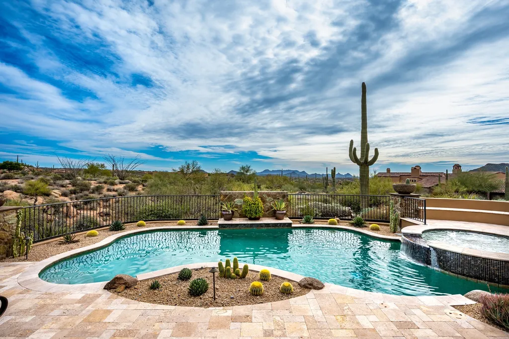 41781 N 99th Way Home in Scottsdale, Arizona. Explore this splendid Old World estate with GOLF Membership available, showcasing warmth, comfort, and unparalleled quality. From the intricately designed interiors to the resort-style patio and serene view terrace, every detail exudes thoughtful craftsmanship and fine materials. 