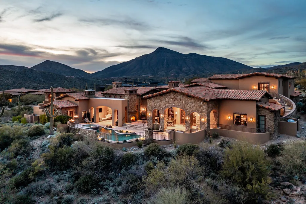 41781 N 99th Way Home in Scottsdale, Arizona. Explore this splendid Old World estate with GOLF Membership available, showcasing warmth, comfort, and unparalleled quality. From the intricately designed interiors to the resort-style patio and serene view terrace, every detail exudes thoughtful craftsmanship and fine materials. 