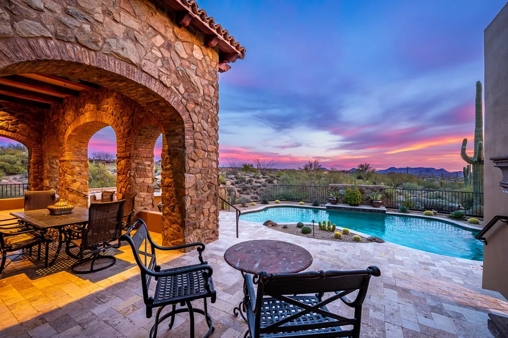 41781 N 99th Way Home in Scottsdale, Arizona. Explore this splendid Old World estate with GOLF Membership available, showcasing warmth, comfort, and unparalleled quality. From the intricately designed interiors to the resort-style patio and serene view terrace, every detail exudes thoughtful craftsmanship and fine materials. 