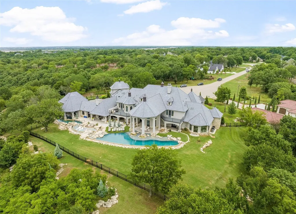 5862 North Eagle Summit Road Home in Owasso, Oklahoma. Step into luxury with this exceptional mansion in the prestigious Bluffs at Stone Canyon. Featuring a grand entry foyer, artistic half baths, a spacious Great Room with a fireplace, and a stunning Master Suite offering breathtaking views and a luxurious spa bath, this home epitomizes elegance. Enjoy the convenience of multiple laundry rooms, a gourmet kitchen with high-end appliances, two Executive Office Suites, a game room with a wet bar and theater room, and three additional bedrooms with private baths.