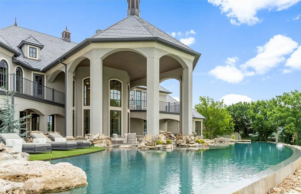 5862 North Eagle Summit Road Home in Owasso, Oklahoma. Step into luxury with this exceptional mansion in the prestigious Bluffs at Stone Canyon. Featuring a grand entry foyer, artistic half baths, a spacious Great Room with a fireplace, and a stunning Master Suite offering breathtaking views and a luxurious spa bath, this home epitomizes elegance. Enjoy the convenience of multiple laundry rooms, a gourmet kitchen with high-end appliances, two Executive Office Suites, a game room with a wet bar and theater room, and three additional bedrooms with private baths.