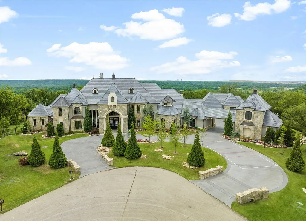5862 North Eagle Summit Road Home in Owasso, Oklahoma. Step into luxury with this exceptional mansion in the prestigious Bluffs at Stone Canyon. Featuring a grand entry foyer, artistic half baths, a spacious Great Room with a fireplace, and a stunning Master Suite offering breathtaking views and a luxurious spa bath, this home epitomizes elegance. Enjoy the convenience of multiple laundry rooms, a gourmet kitchen with high-end appliances, two Executive Office Suites, a game room with a wet bar and theater room, and three additional bedrooms with private baths.