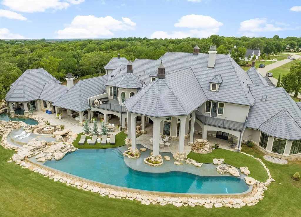 5862 North Eagle Summit Road Home in Owasso, Oklahoma. Step into luxury with this exceptional mansion in the prestigious Bluffs at Stone Canyon. Featuring a grand entry foyer, artistic half baths, a spacious Great Room with a fireplace, and a stunning Master Suite offering breathtaking views and a luxurious spa bath, this home epitomizes elegance. Enjoy the convenience of multiple laundry rooms, a gourmet kitchen with high-end appliances, two Executive Office Suites, a game room with a wet bar and theater room, and three additional bedrooms with private baths.