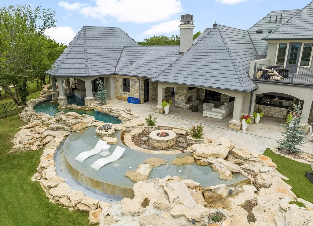 5862 North Eagle Summit Road Home in Owasso, Oklahoma. Step into luxury with this exceptional mansion in the prestigious Bluffs at Stone Canyon. Featuring a grand entry foyer, artistic half baths, a spacious Great Room with a fireplace, and a stunning Master Suite offering breathtaking views and a luxurious spa bath, this home epitomizes elegance. Enjoy the convenience of multiple laundry rooms, a gourmet kitchen with high-end appliances, two Executive Office Suites, a game room with a wet bar and theater room, and three additional bedrooms with private baths.