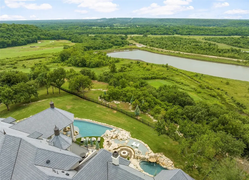 5862 North Eagle Summit Road Home in Owasso, Oklahoma. Step into luxury with this exceptional mansion in the prestigious Bluffs at Stone Canyon. Featuring a grand entry foyer, artistic half baths, a spacious Great Room with a fireplace, and a stunning Master Suite offering breathtaking views and a luxurious spa bath, this home epitomizes elegance. Enjoy the convenience of multiple laundry rooms, a gourmet kitchen with high-end appliances, two Executive Office Suites, a game room with a wet bar and theater room, and three additional bedrooms with private baths.