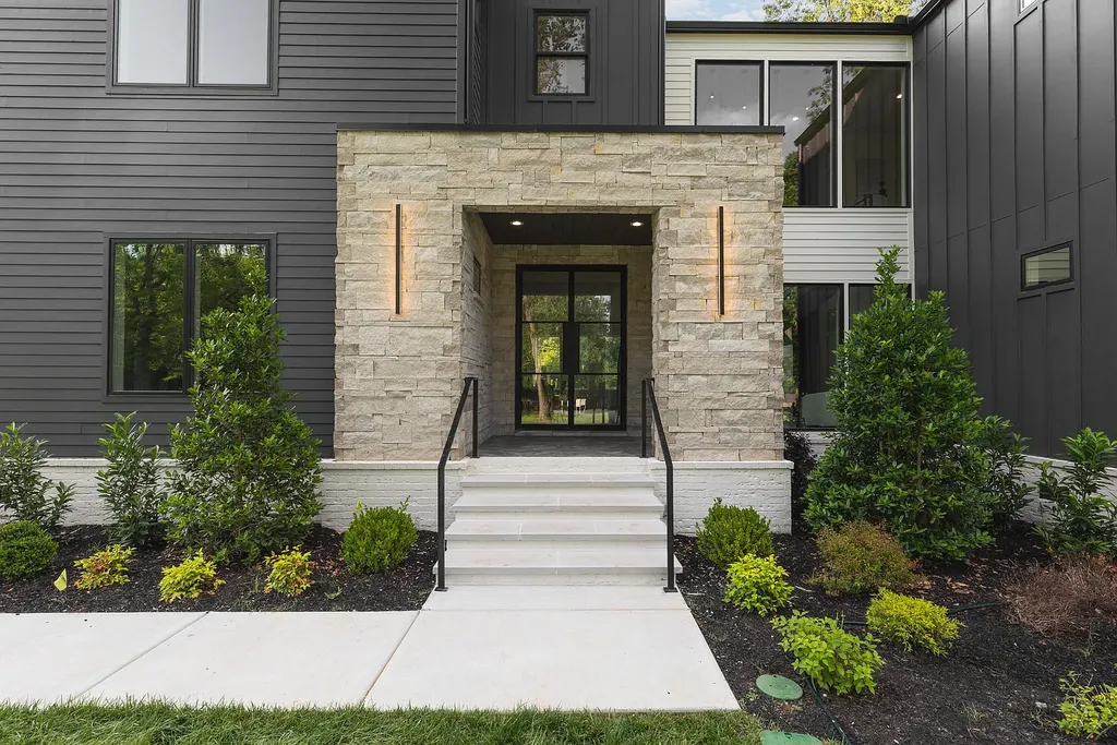 6240 Bresslyn Road Home in Nashville, Tennessee. Province Builders LLC & Laura Greene Interiors have created a stunning contemporary masterpiece on a spacious one-acre lot in the desirable West Meade neighborhood. This home showcases impeccable attention to detail and a tasteful blend of sophistication and modernity. 