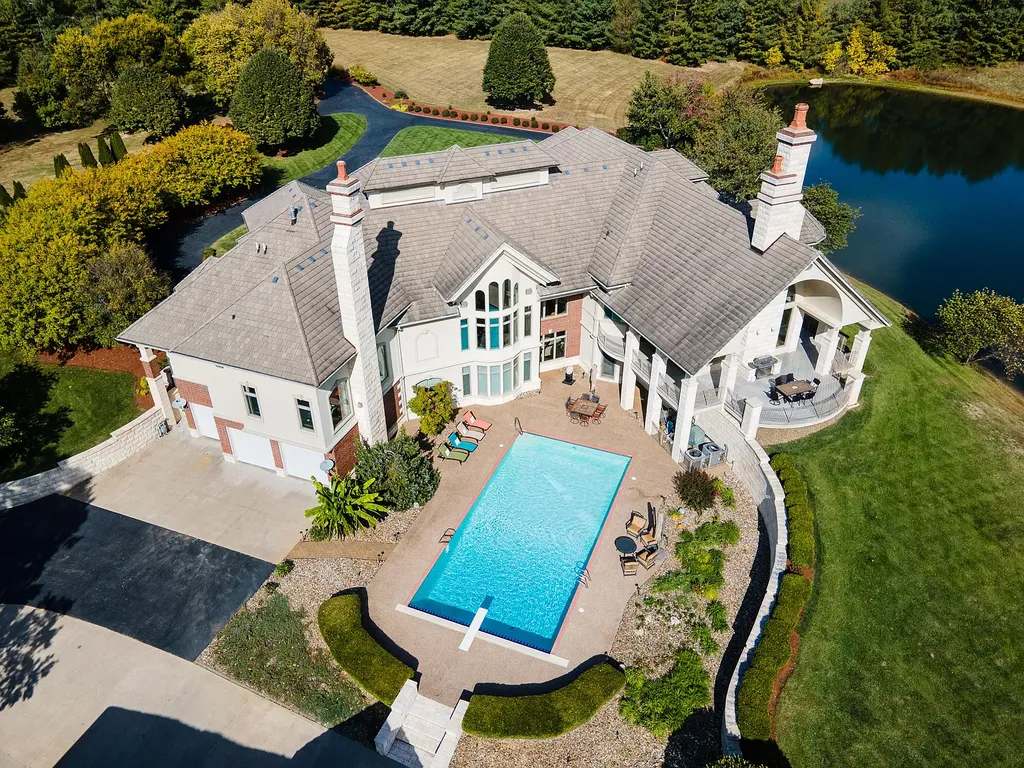 6800 S Lakota Ridge Lane Home in Columbia, Missouri. Discover the epitome of luxury living in this one-of-a-kind 11,000 square foot estate in southern Columbia. Boasting imported Israeli stone, soaring 28-foot ceilings, alabaster light fixtures, heated floors, and a stunning 30-foot waterfall, this home is truly extraordinary. 