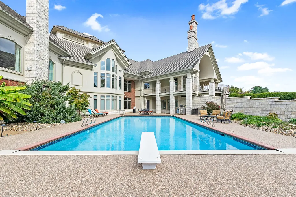 6800 S Lakota Ridge Lane Home in Columbia, Missouri. Discover the epitome of luxury living in this one-of-a-kind 11,000 square foot estate in southern Columbia. Boasting imported Israeli stone, soaring 28-foot ceilings, alabaster light fixtures, heated floors, and a stunning 30-foot waterfall, this home is truly extraordinary. 