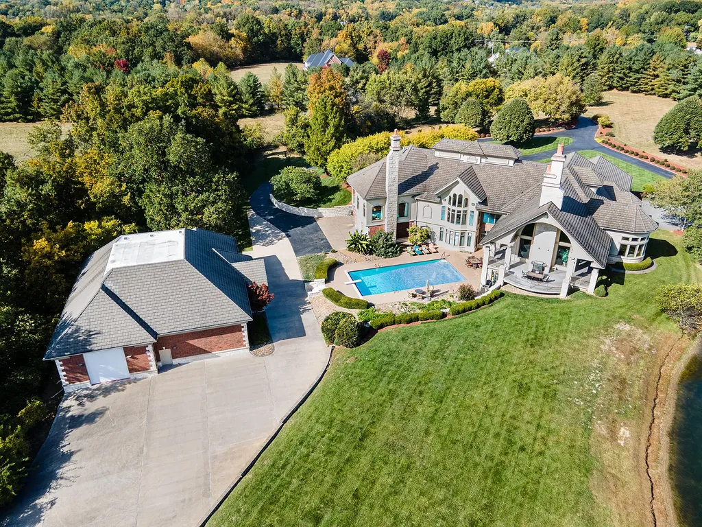 6800 S Lakota Ridge Lane Home in Columbia, Missouri. Discover the epitome of luxury living in this one-of-a-kind 11,000 square foot estate in southern Columbia. Boasting imported Israeli stone, soaring 28-foot ceilings, alabaster light fixtures, heated floors, and a stunning 30-foot waterfall, this home is truly extraordinary. 