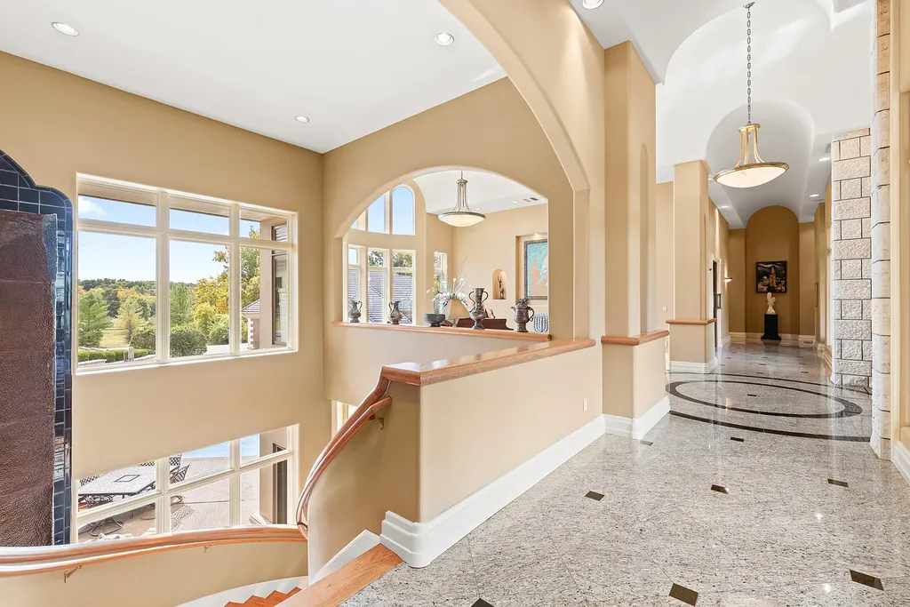6800 S Lakota Ridge Lane Home in Columbia, Missouri. Discover the epitome of luxury living in this one-of-a-kind 11,000 square foot estate in southern Columbia. Boasting imported Israeli stone, soaring 28-foot ceilings, alabaster light fixtures, heated floors, and a stunning 30-foot waterfall, this home is truly extraordinary. 