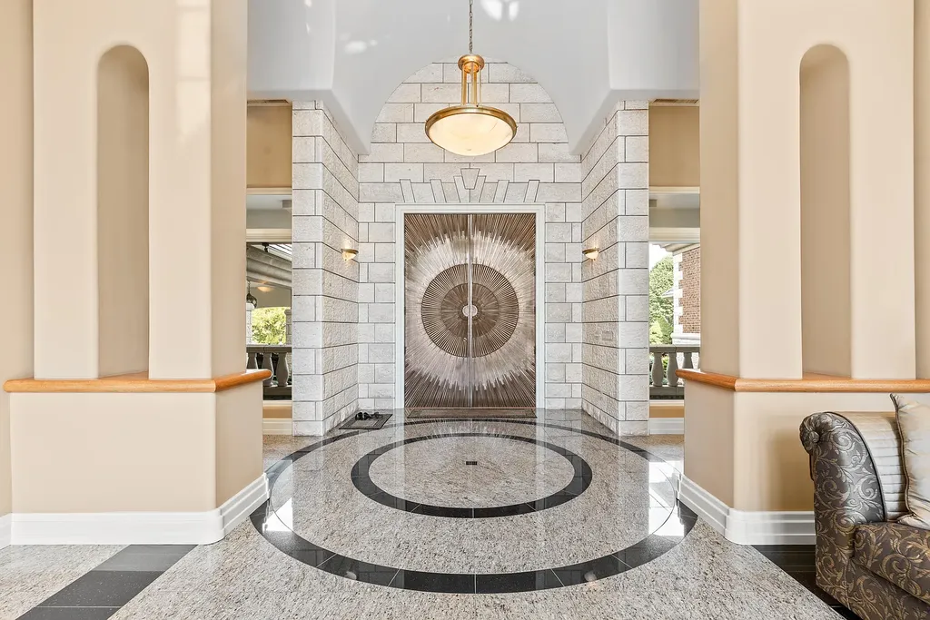 6800 S Lakota Ridge Lane Home in Columbia, Missouri. Discover the epitome of luxury living in this one-of-a-kind 11,000 square foot estate in southern Columbia. Boasting imported Israeli stone, soaring 28-foot ceilings, alabaster light fixtures, heated floors, and a stunning 30-foot waterfall, this home is truly extraordinary. 