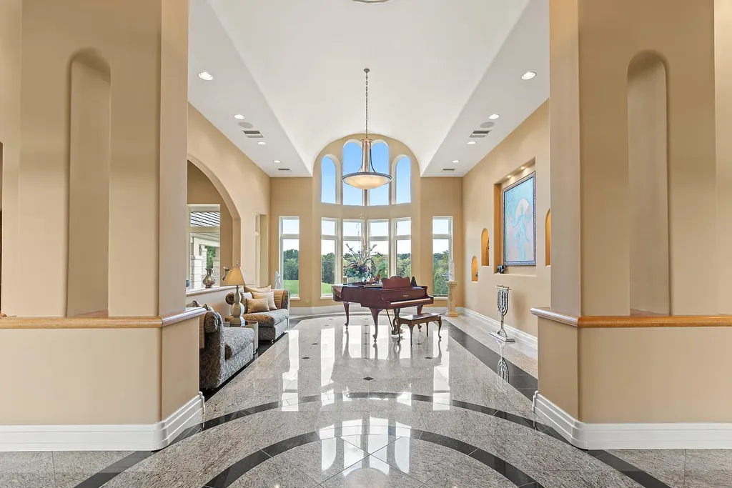 6800 S Lakota Ridge Lane Home in Columbia, Missouri. Discover the epitome of luxury living in this one-of-a-kind 11,000 square foot estate in southern Columbia. Boasting imported Israeli stone, soaring 28-foot ceilings, alabaster light fixtures, heated floors, and a stunning 30-foot waterfall, this home is truly extraordinary. 