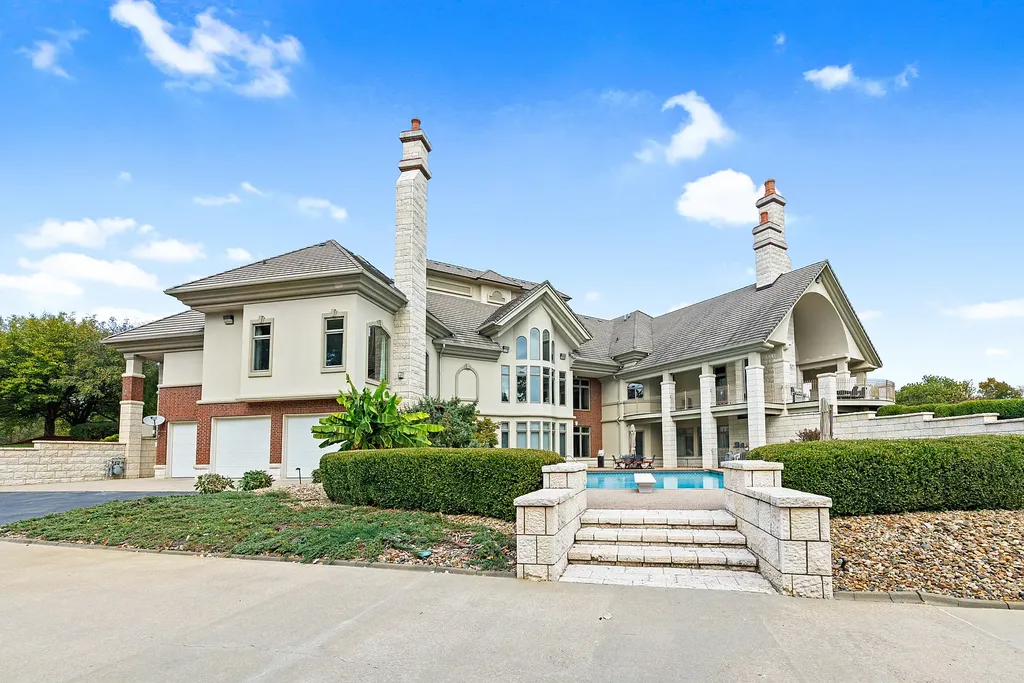 6800 S Lakota Ridge Lane Home in Columbia, Missouri. Discover the epitome of luxury living in this one-of-a-kind 11,000 square foot estate in southern Columbia. Boasting imported Israeli stone, soaring 28-foot ceilings, alabaster light fixtures, heated floors, and a stunning 30-foot waterfall, this home is truly extraordinary. 